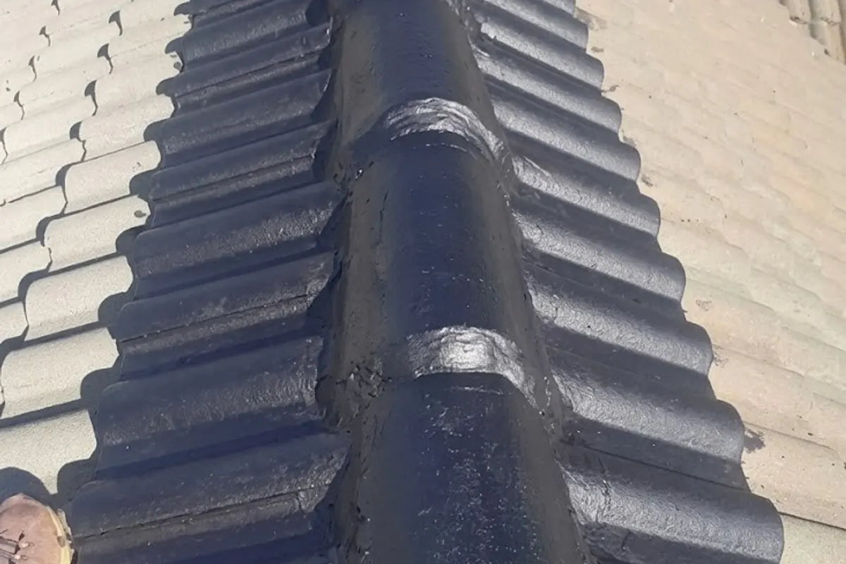 Close-up of a freshly painted waterproof roof ridge coating, showing finish quality